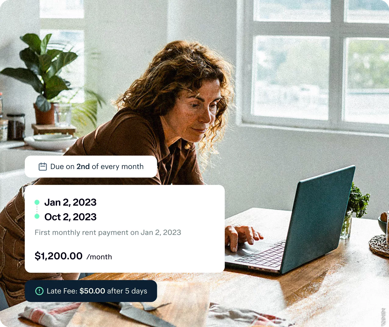A person with curly hair is using a laptop at a wooden table with various items in the background. The screen displays a rental payment schedule: $1200/month, due on the 2nd of each month, with additional info like due dates, late fees, and the first payment date.