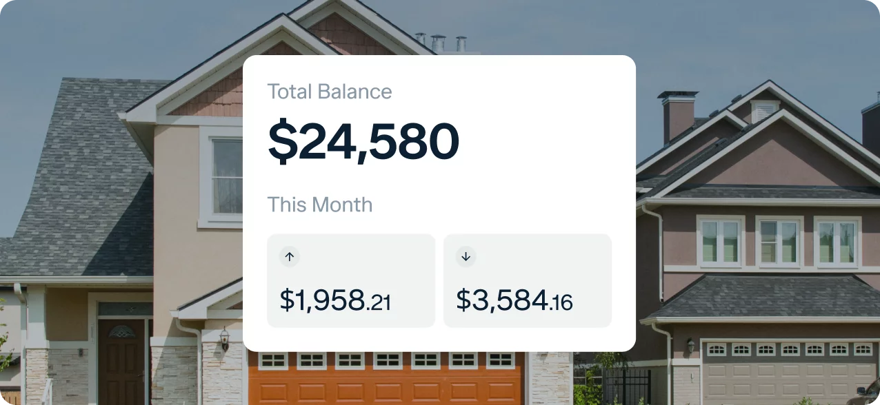 A screenshot shows a financial dashboard overlayed on a background image of houses. The dashboard displays a "Total Balance" of $24,580 and two sections labeled "This Month" showing amounts $1,958.21 and $3,584.16.
