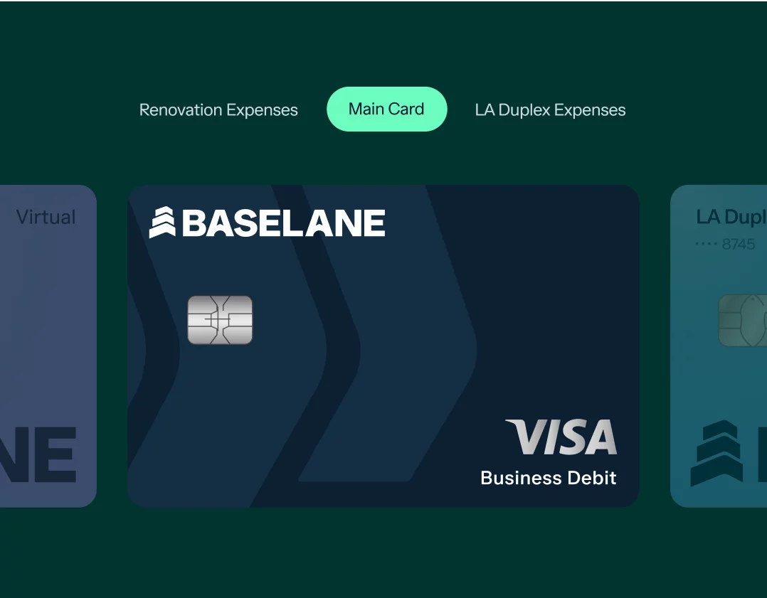 Close-up of a dark blue Baseline Visa Business Debit card displayed on a dark green background. The card is prominently featured in the center, with two other partially visible cards on either side. The card is under the highlighted "Main Card" category.