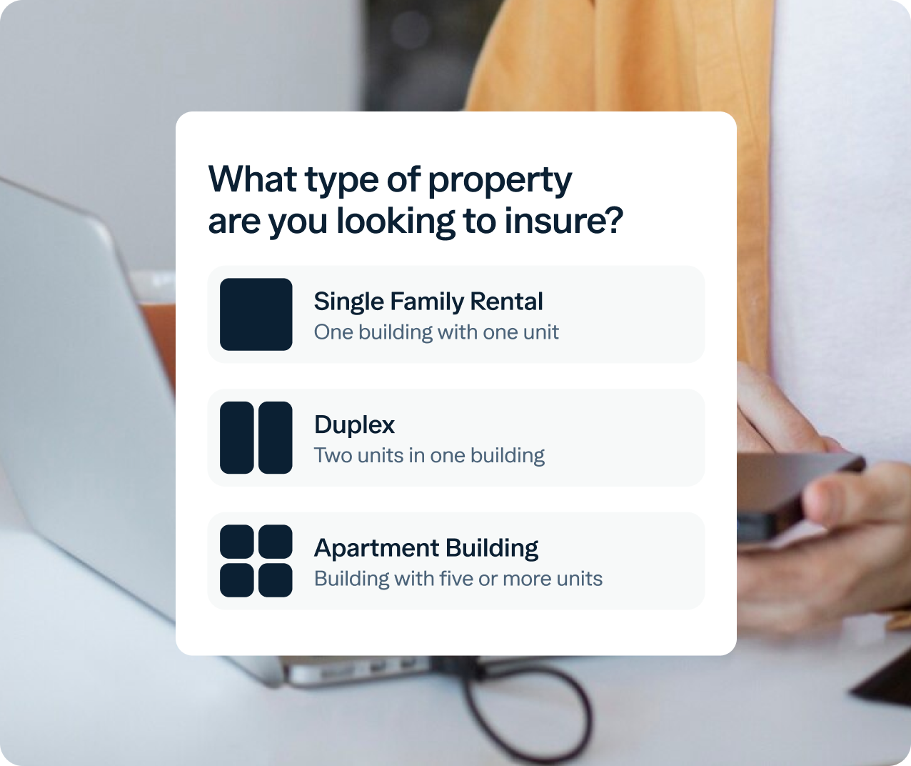 A person holding a phone sits at a desk with an open laptop. A text overlay asks, "What type of property are you looking to insure?" The options below are "Single Family Rental," "Duplex," and "Apartment Building," each with a corresponding icon.