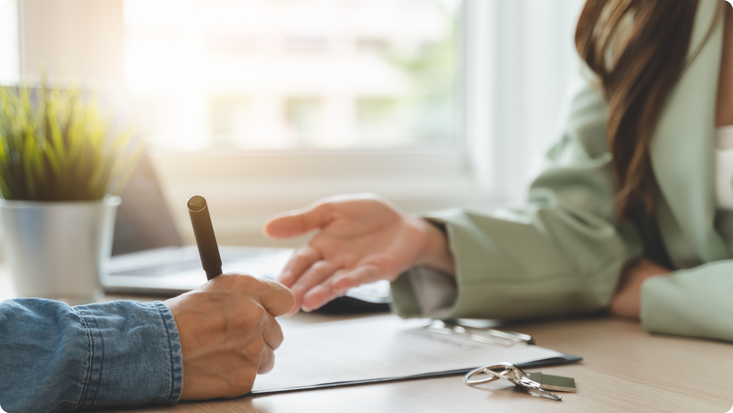 Landlord and tenant reviewing a tenant screening questions at a table.