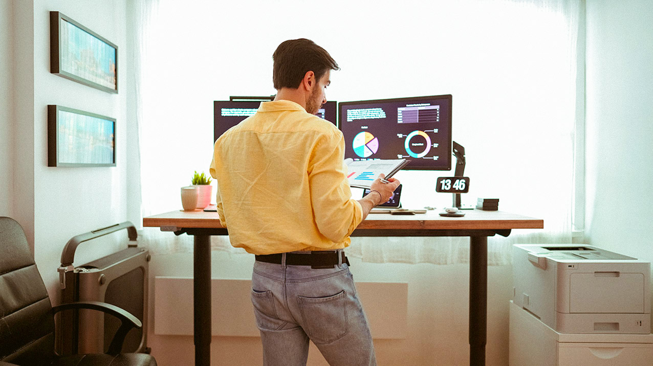 An image showing a man reading a report in an office