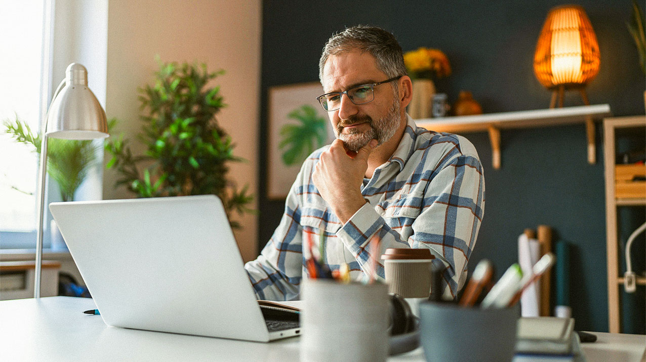 A person sitting at a computer in an office setting