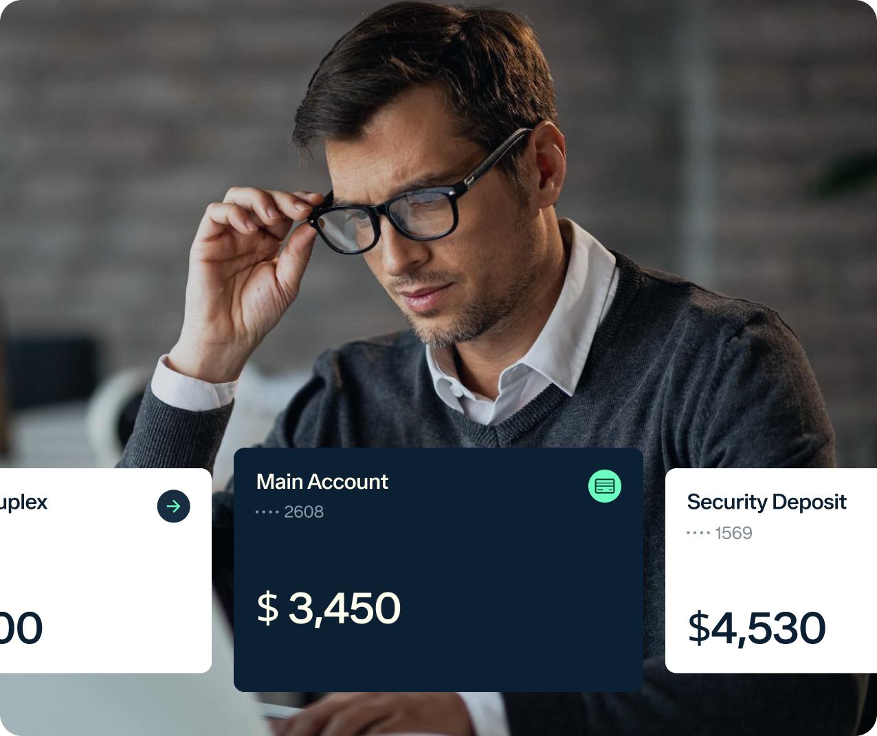 A man wearing glasses and a sweater is sitting at a desk, focused on a computer screen. Two transparent boxes overlay the image, showing amounts of $3,450 for the main account and $4,530 for the security deposit.