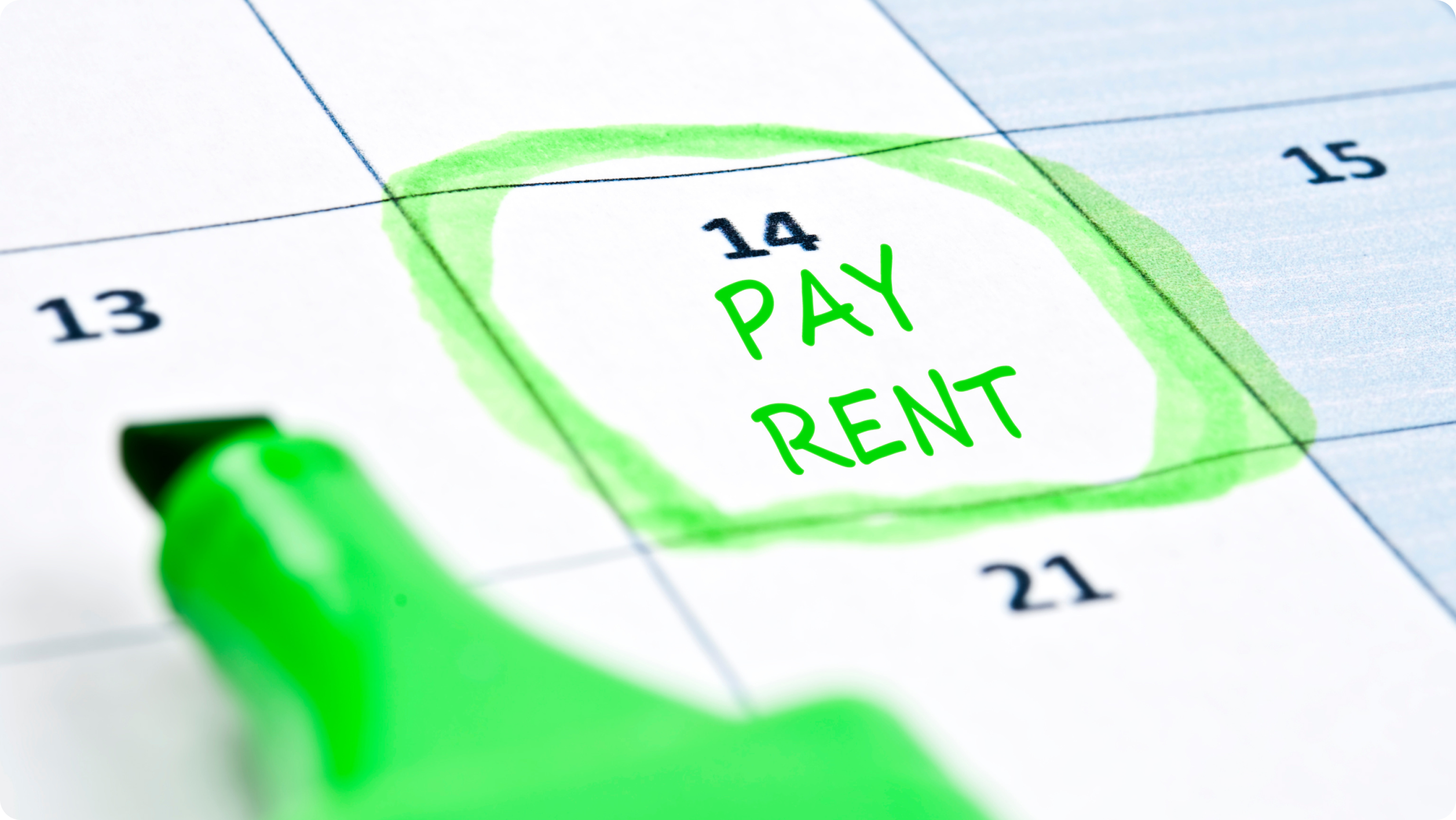 Close-up of calendar with a green circle around the 14th, labeled "Pay Rent" in green marker. A green highlighter is positioned to the left of the calendar.