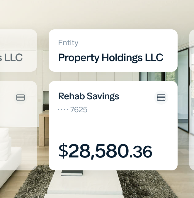 A modern living room with a white couch and table. Overlaid are digital financial details showing "Property Holdings LLC," "Rehab Savings," account ending in 7625, and a balance of $28,580.36.