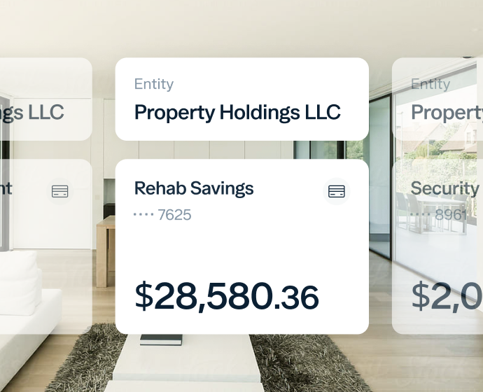 A modern living space with virtual financial overlays displaying account balances. The main overlay shows "Property Holdings LLC" and "Rehab Savings" with an amount of $28,580.36. Other overlays show partial details of different accounts.