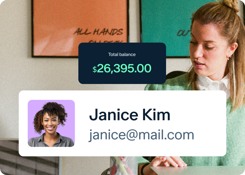 A woman sits at a desk writing, with a notification showing a $26,395.00 balance. A profile card below displays a photo of Janice Kim and her email address, janice@mail.com. Colorful framed prints are on the wall behind her.